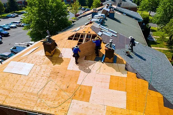 Tile and steel roofing work on a house roof